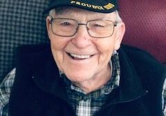 A man wearing glasses and a hat.