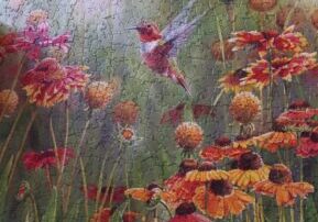 A painting of flowers and birds in the grass.