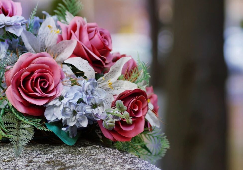 A bouquet of flowers on top of a stone slab.