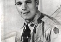 A man in uniform with an umbrella.